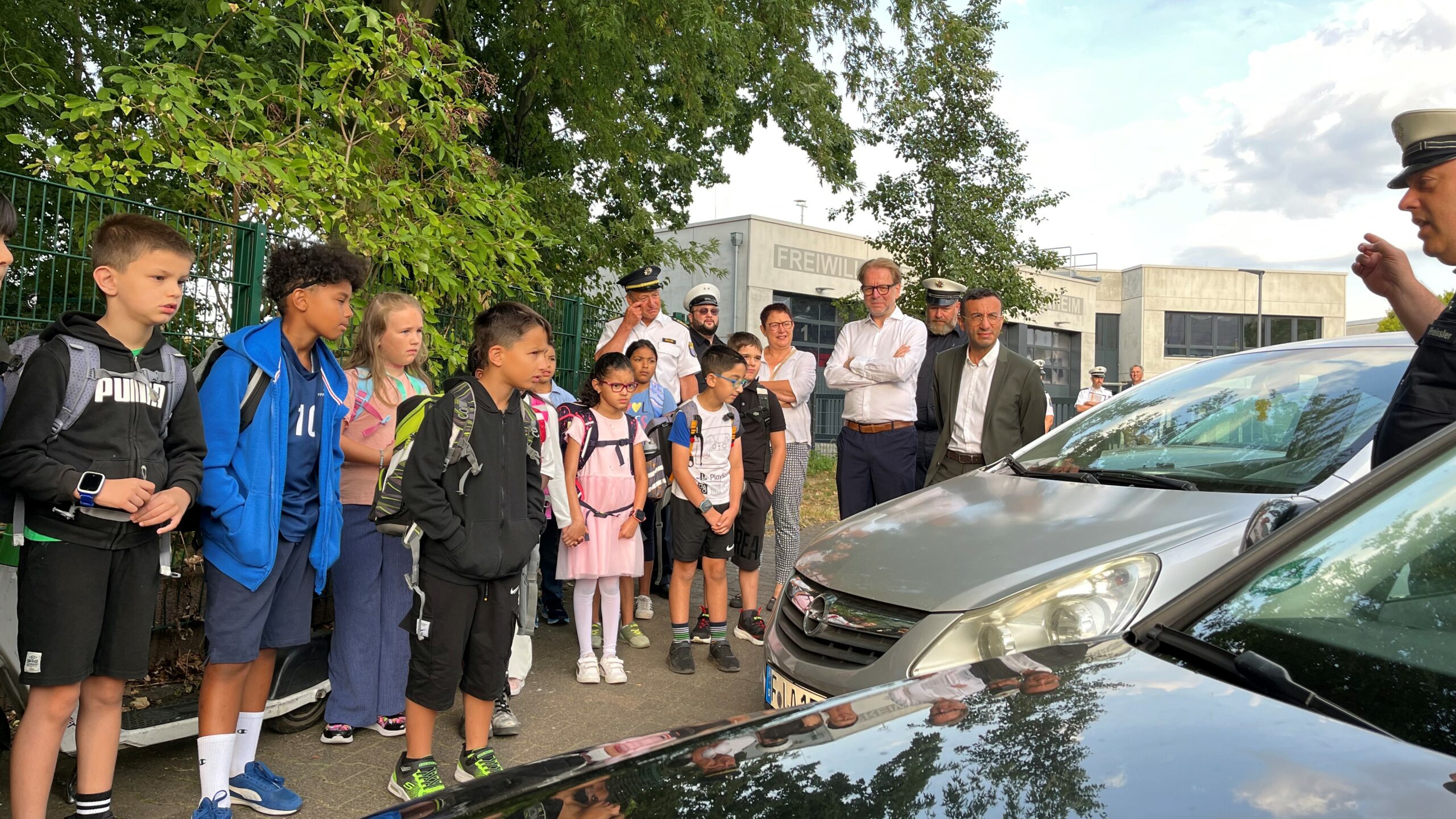 Ein städtischer Verkehrserziehung erklärt Kindern, wie man die Straße sicher überquert.